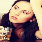 Yound beautiful woman in depression, drinking alcohol