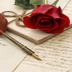 red rose flower, old letters and antique feather pen