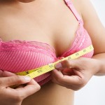 Woman measuring breast size