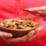 Woman Eating Healthy Snack Of Almonds