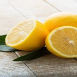 Fresh lemons on wooden background. Selective focus.