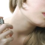 Woman using perfume